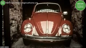 Still from History of Advertising Trust video on cars showing a red Volkswagen Beetle